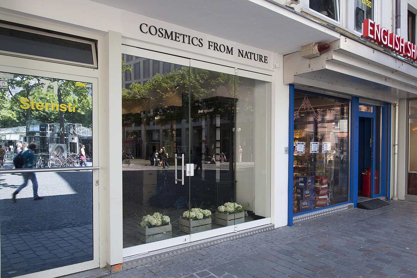 Storefront with frameless folding glass doors