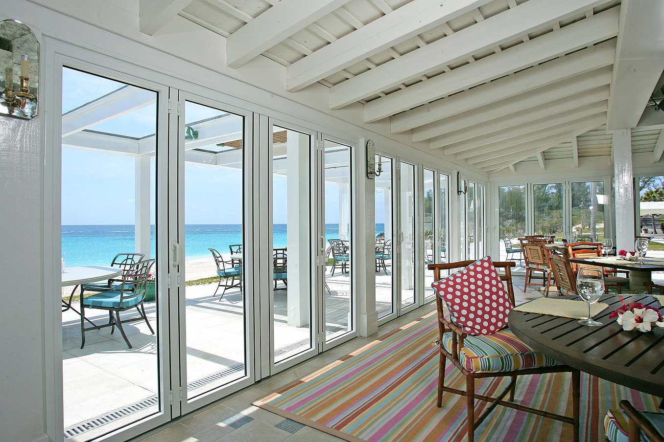 NanaWall impact-rated folding glass wall system at Tucker’s Point in Bermuda, designed for hurricane-prone coastal environments