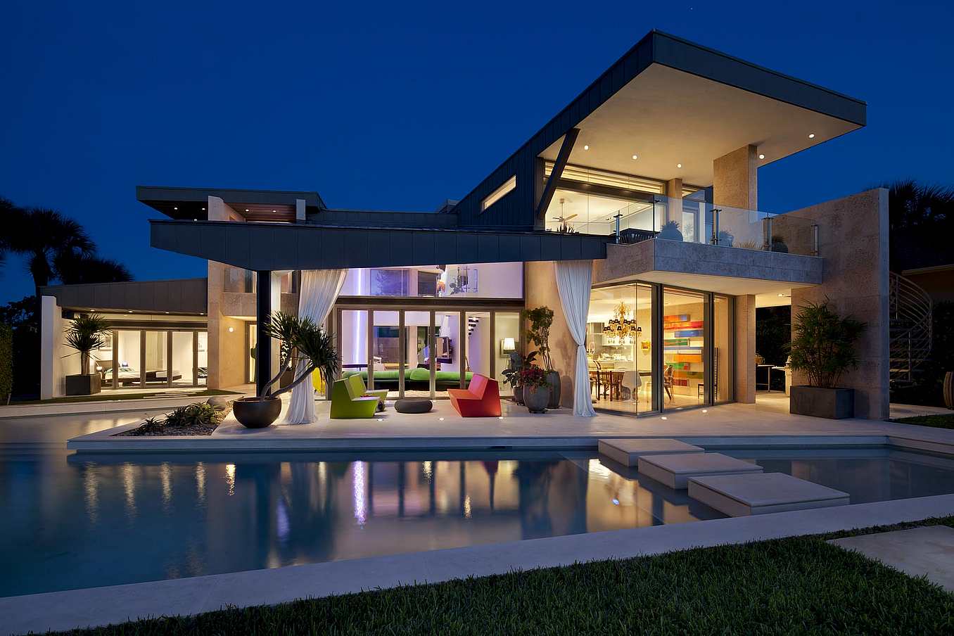 A modern house with a swimming pool at nigh
