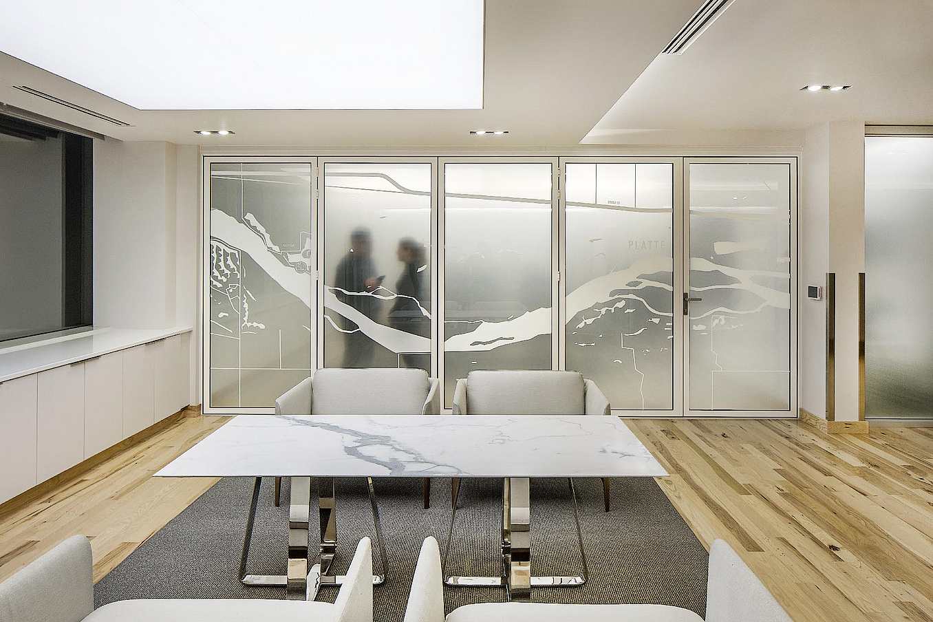 Law office reception area with NanaWall SL45 glass walls opening to adjacent workspaces
