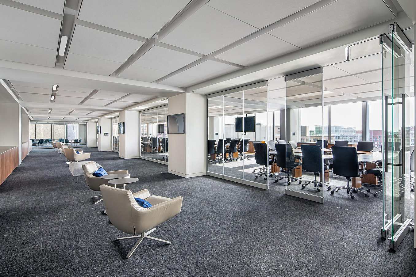 Management consulting firm office with NanaWall PrivaSEE sliding glass partitions creating private meeting rooms