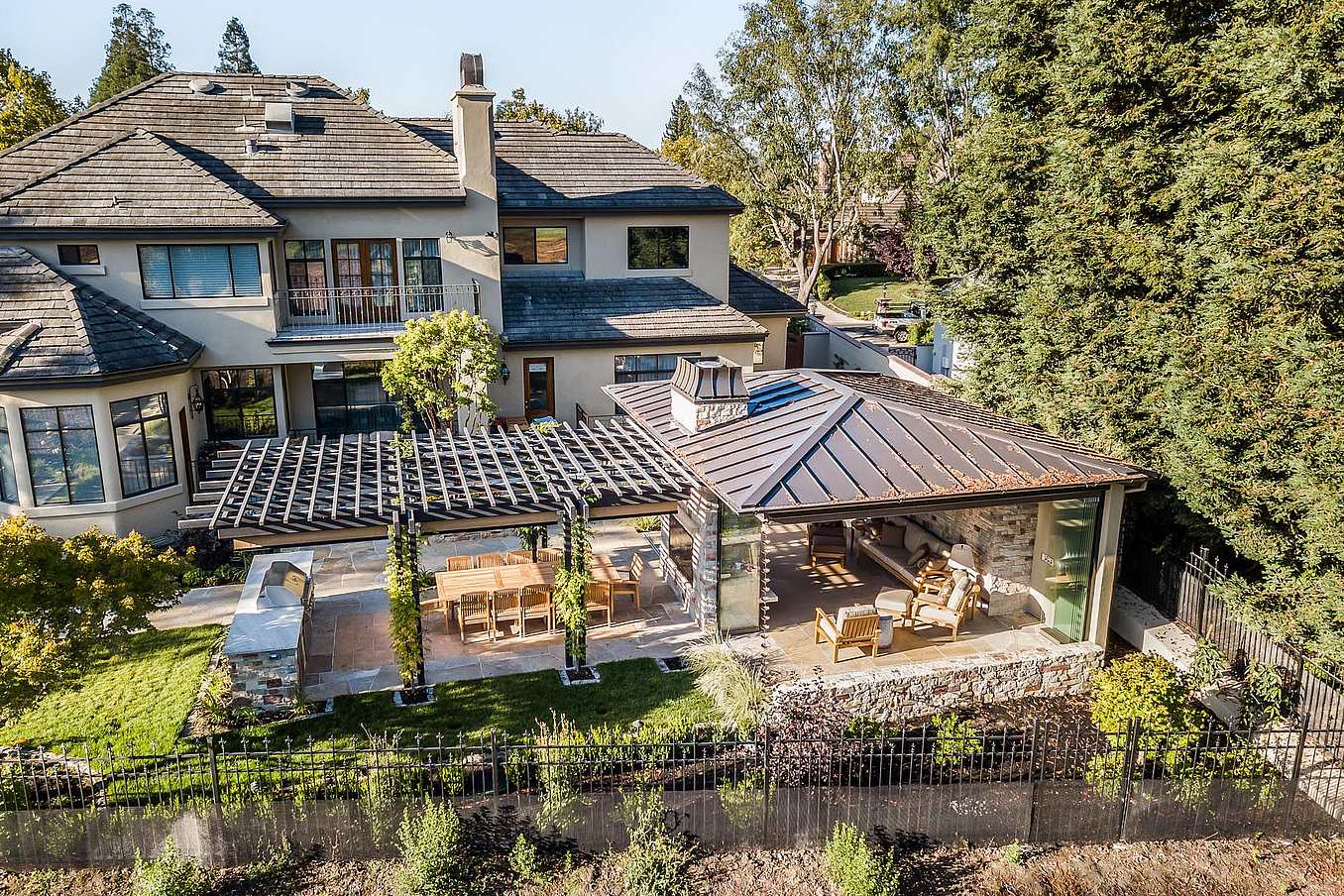 Frameless patio doors in Deer Creek residence enhance seamless indoor-outdoor living with expansive glass panels