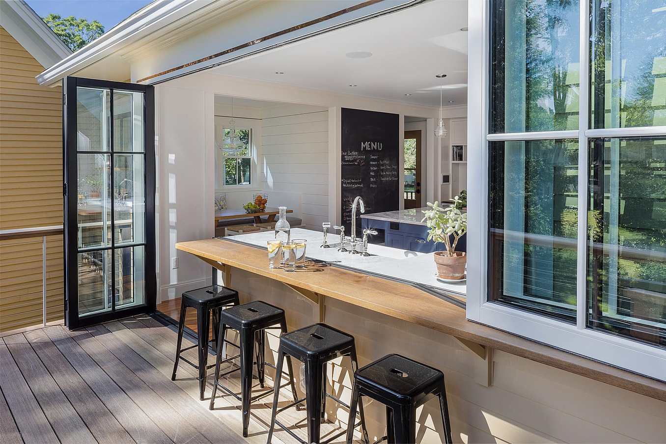 NanaWall at Needham House, showcasing wood-framed folding glass walls with thermal insulation, custom finish, and indoor-outdoor flow