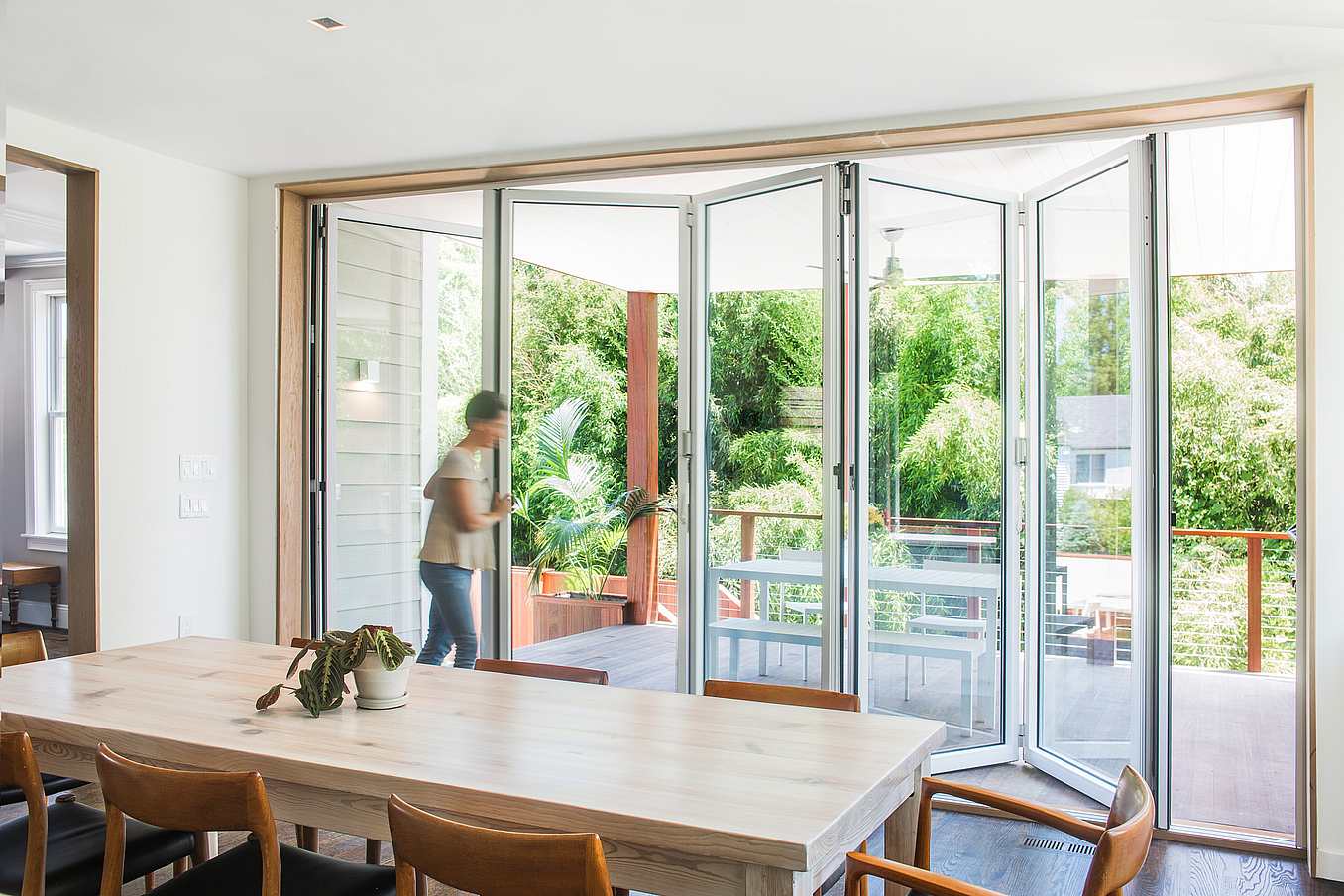 Accordion glass patio doors in Bethesda, MD integrate indoor and outdoor space for seamless, modern living environments