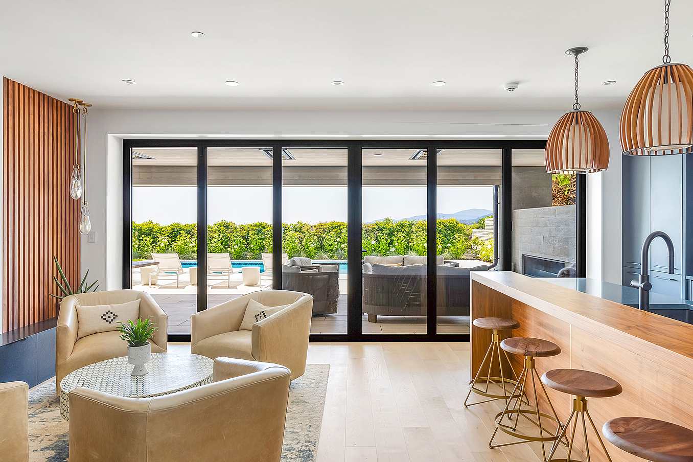NanaWall thermally broken glass wall system with large floor-to-ceiling panels, shown at a modern hillside residence