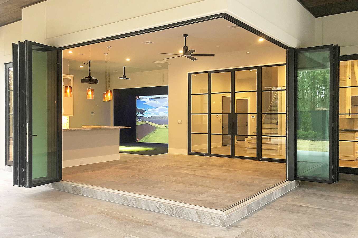 Modern open-concept living space featuring zero corner folding glass doors