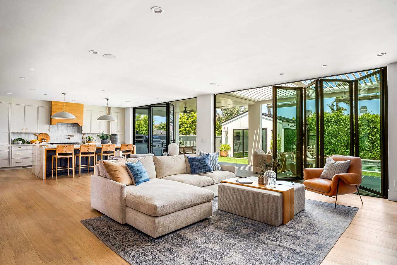 Accordion glass doors seamlessly connect your living space to outdoor gardens, enhancing light, flow, and modern style