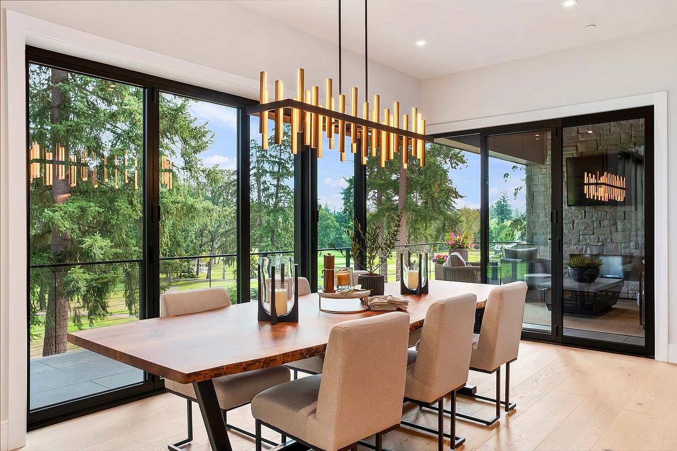 Thermally broken NanaWall NW Aluminum 640 folding glass wall system shown closed in a dining room, providing full weather protection and thermal performance