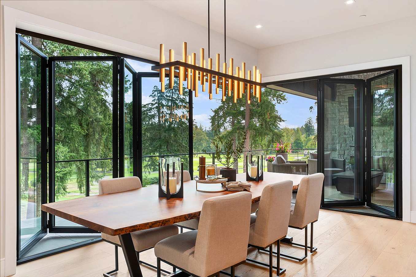 Thermally broken NanaWall NW Aluminum 640 folding glass wall system partially opened, demonstrating smooth panel operation and flexible indoor–outdoor transition