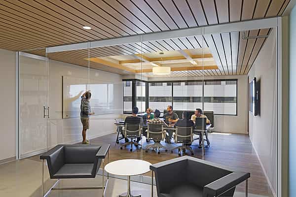 Flexible acoustical glass walls within office interior space