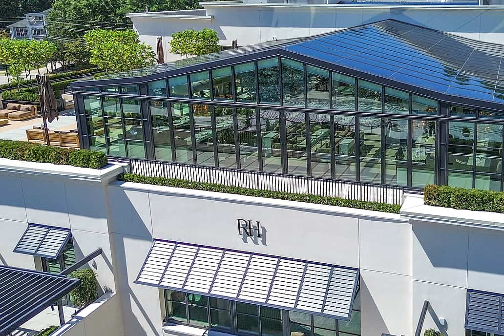 Restoration Hardware rooftop restaurant in Raleigh NC featuring modern white building with NanaWall SL70 bifold glass doors, large windows, and glass-enclosed rooftop dining area.