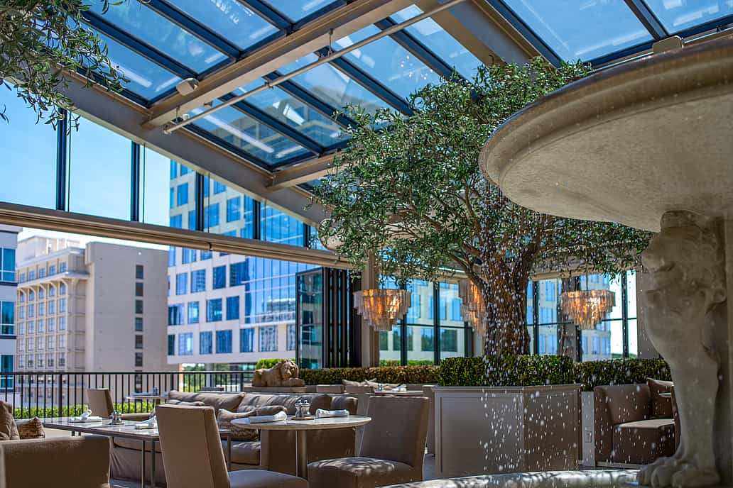 Restoration Hardware rooftop restaurant in Raleigh NC highlighting NanaWall SL70 bifold glass doors as the main feature connecting elegant indoor dining with open-air terrace surrounded by modern décor and city views