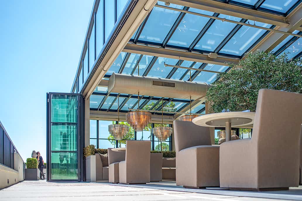 Restoration Hardware rooftop restaurant in Raleigh NC featuring NanaWall SL70 bifold glass doors opening to a modern terrace for al fresco dining with city views