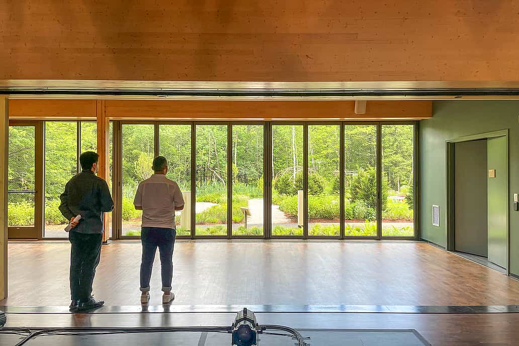NanaWall thermally broken glass wall system at Jacob’s Pillow in Becket, MA, opening to a landscaped outdoor view from a studio space