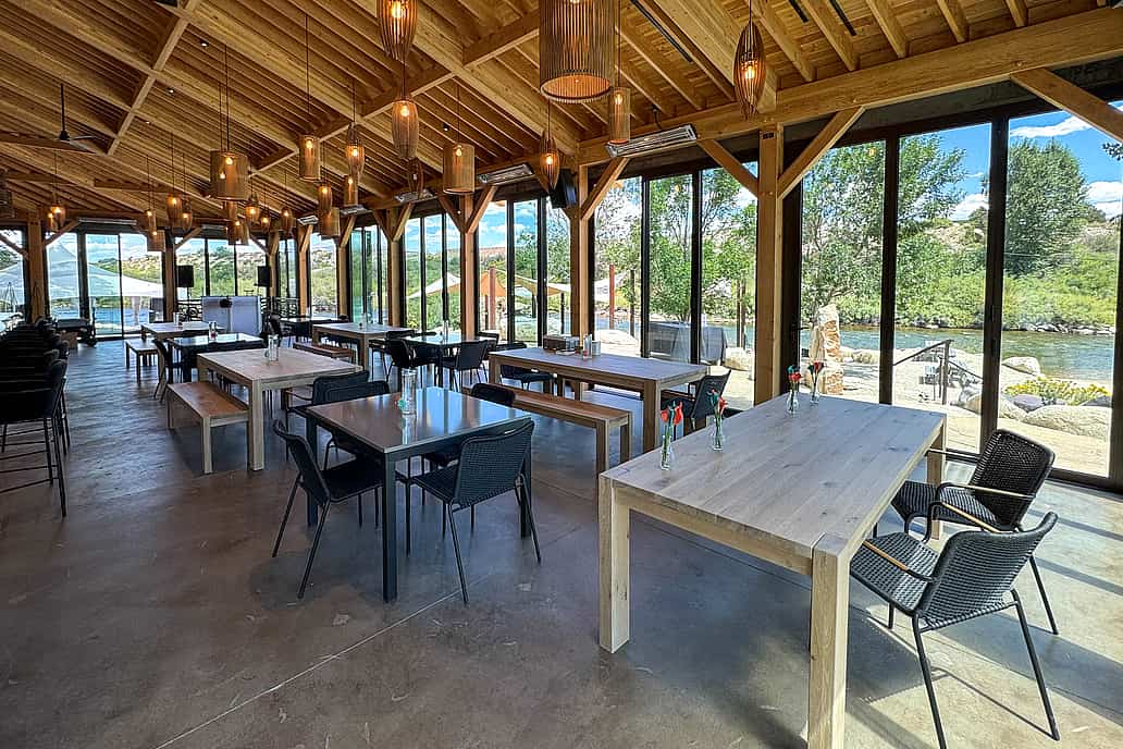 NanaWall thermally broken NW Aluminum 640 glass wall at The Beach Restaurant in Buena Vista, CO, partially open to connect the indoor dining area with the outdoor patio