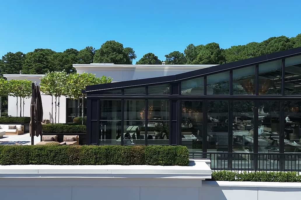 RH Raleigh Rooftop Restaurant in Raleigh NC with NanaWall SL70 folding glass wall opening elegant dining space to outdoor terrace