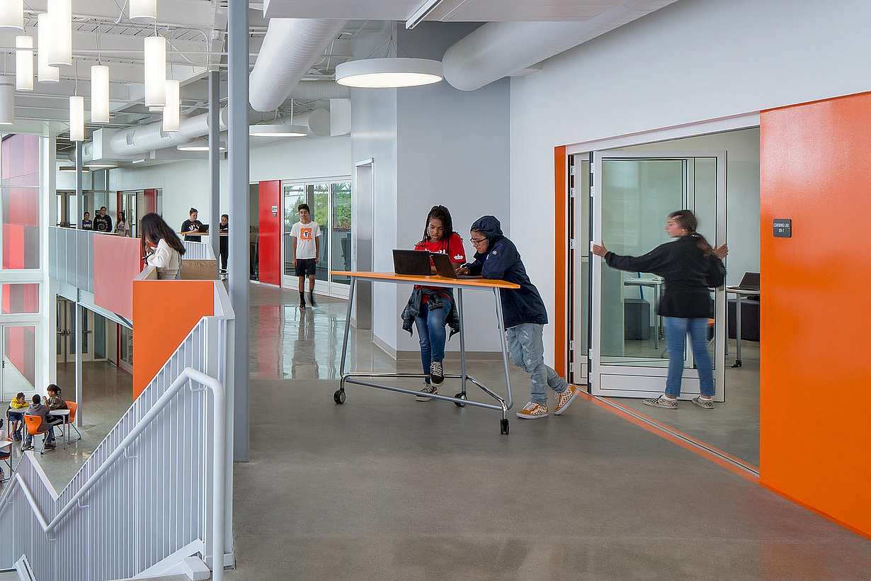 student opporating folding door in one of the  21st century classrooms at rio del sol academy