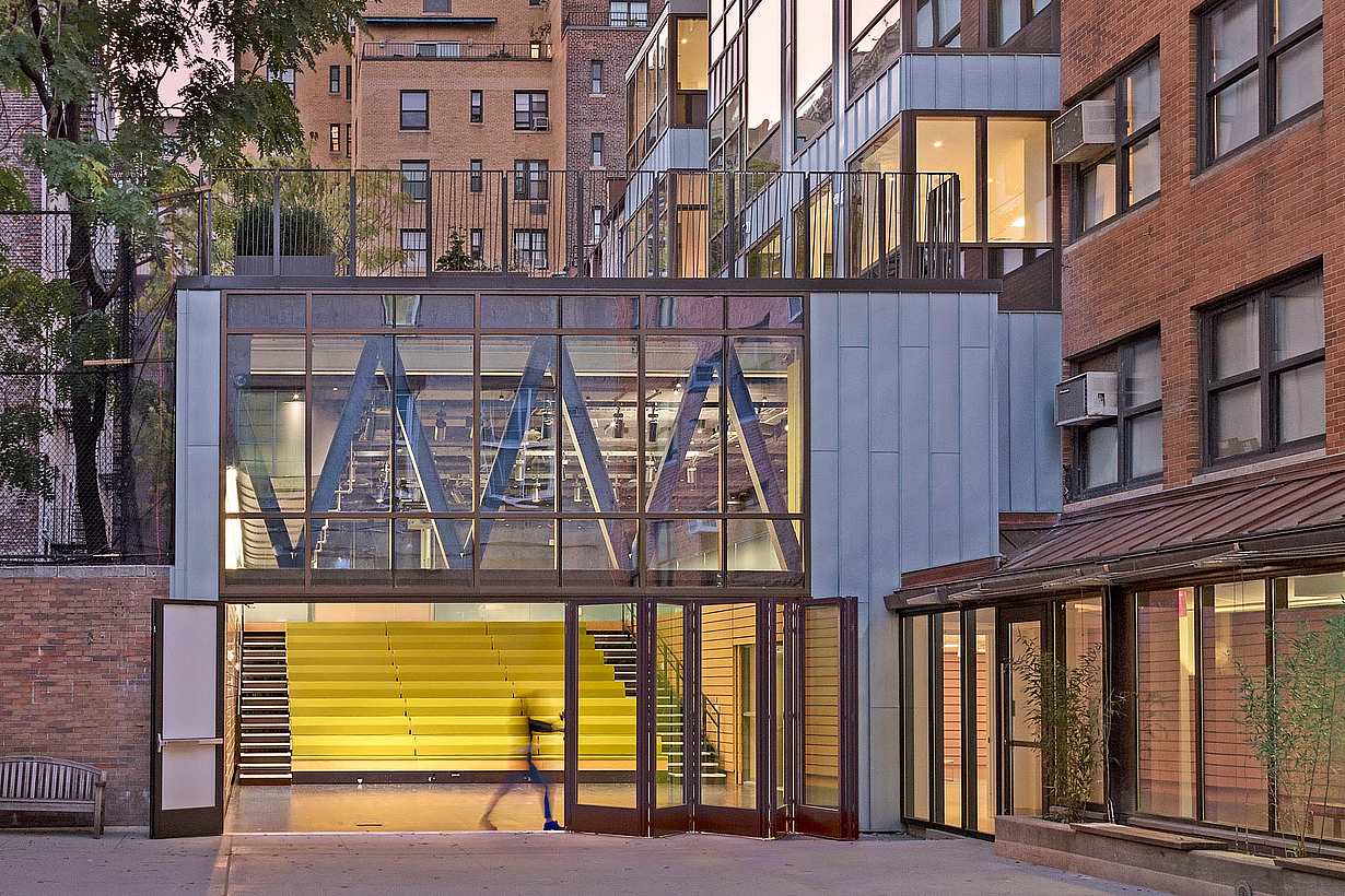teacher opening folding glass wall in 21st century school design