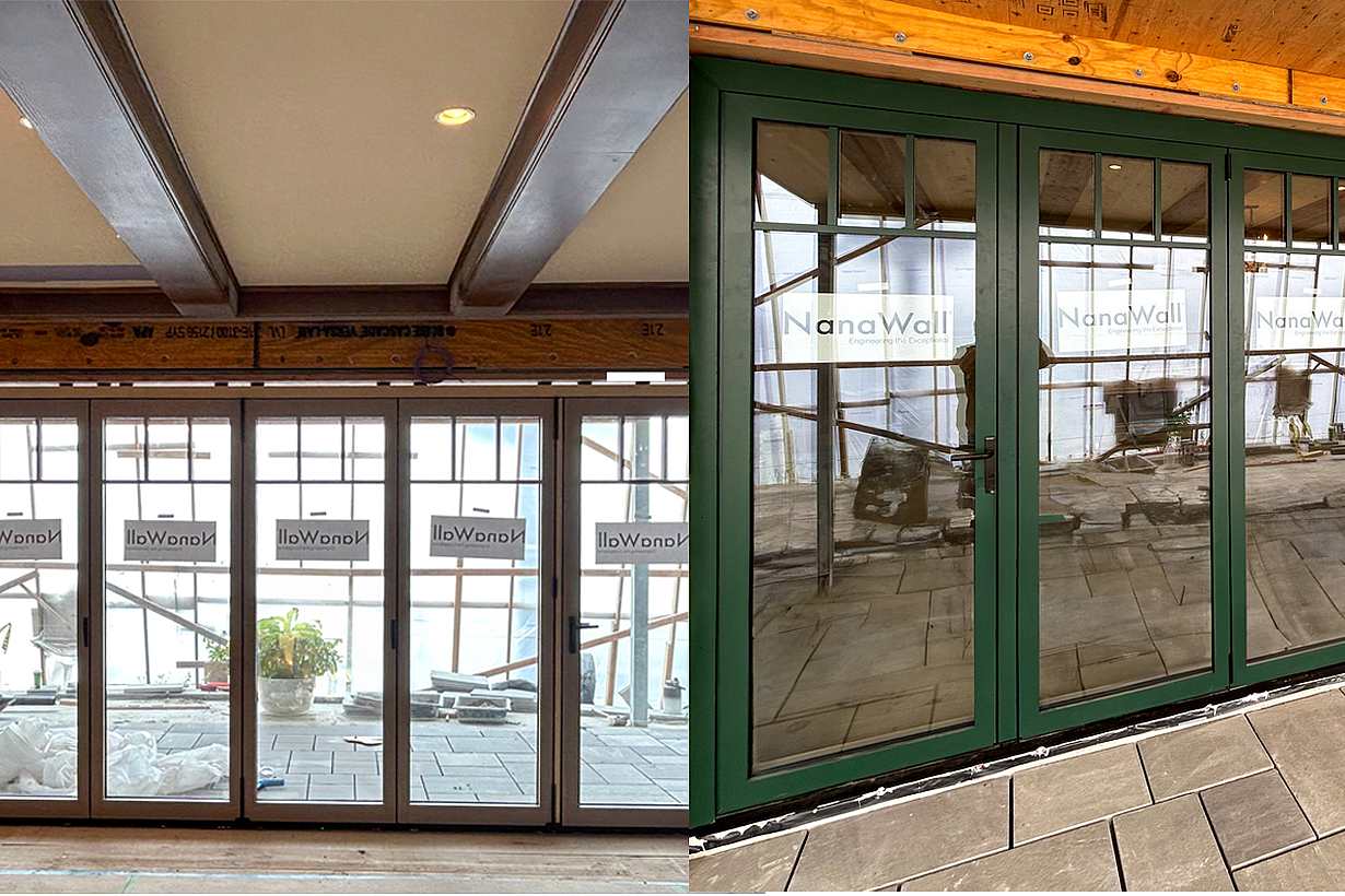 Large set of floor-to-ceiling folding glass doors finished in a dark green powder-coated exterior and rich wood interior.