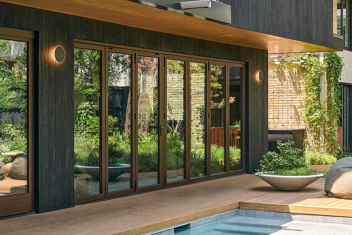 opening glass door system in pool house design