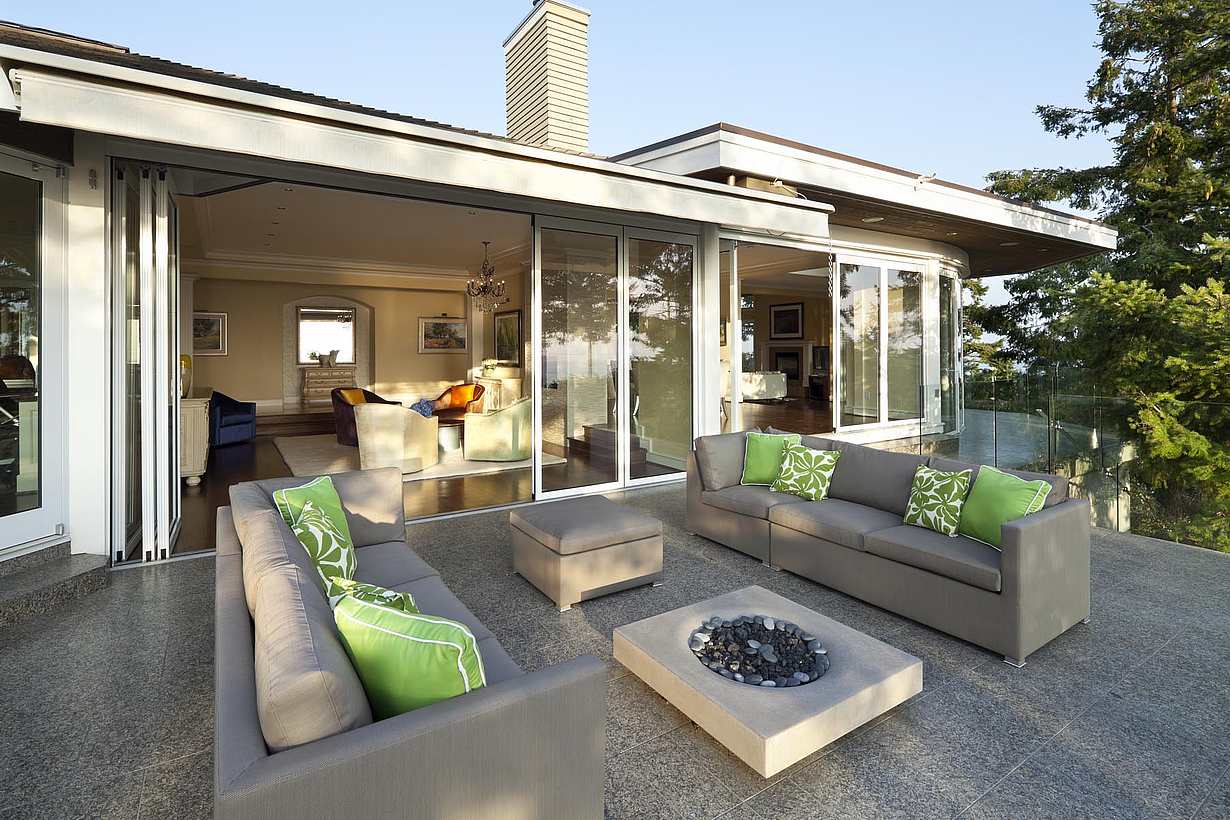 Partially open sliding patio doors slide into parking bay area in Pacific Northwest residence