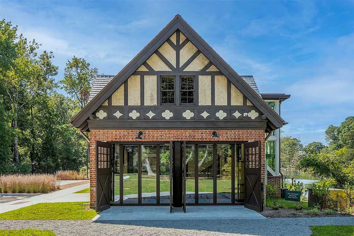 Historic barn conversion exterior featuring bifolding patio doors that open the interior to the surrounding landscape