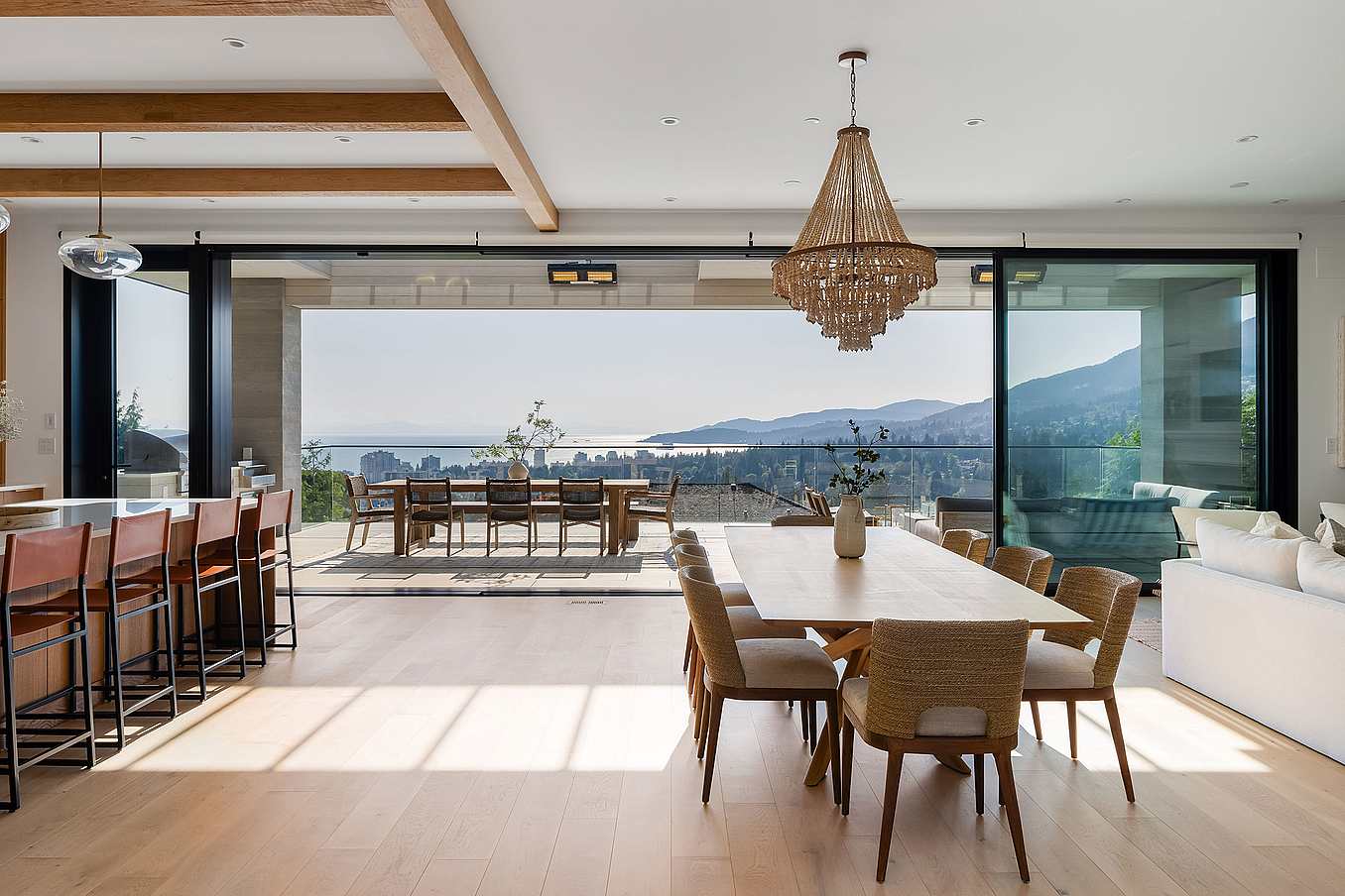 NanaWall sliding glass wall system in a West Vancouver residence, opening a kitchen to a scenic outdoor balcony