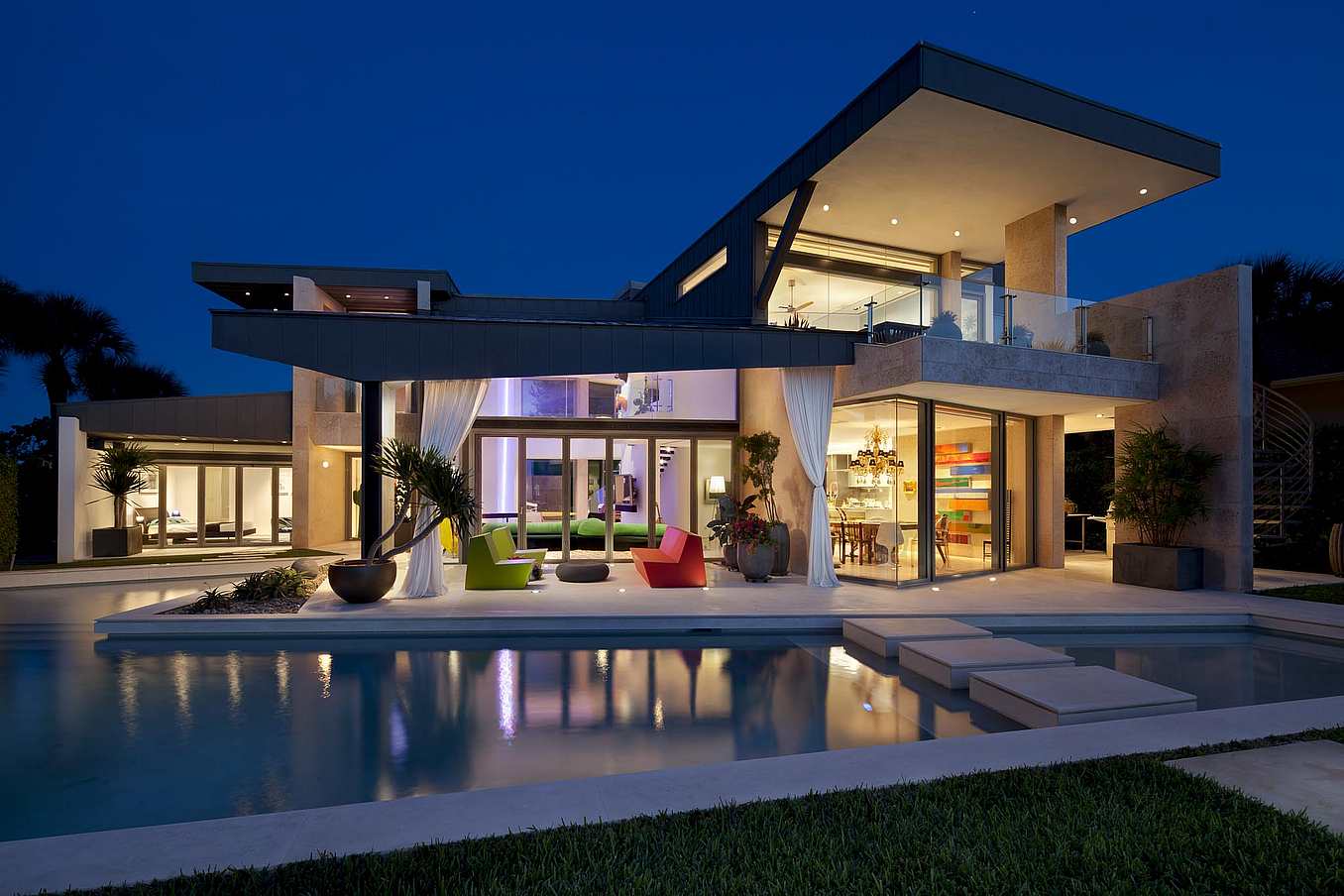 A modern house with a swimming pool at nigh