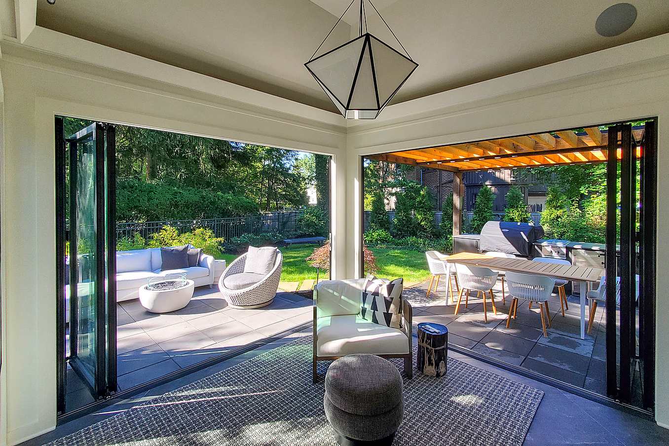 Bifold glass patio doors in Dorchester, MA integrate indoor and outdoor space, expanding living areas with modern elegance