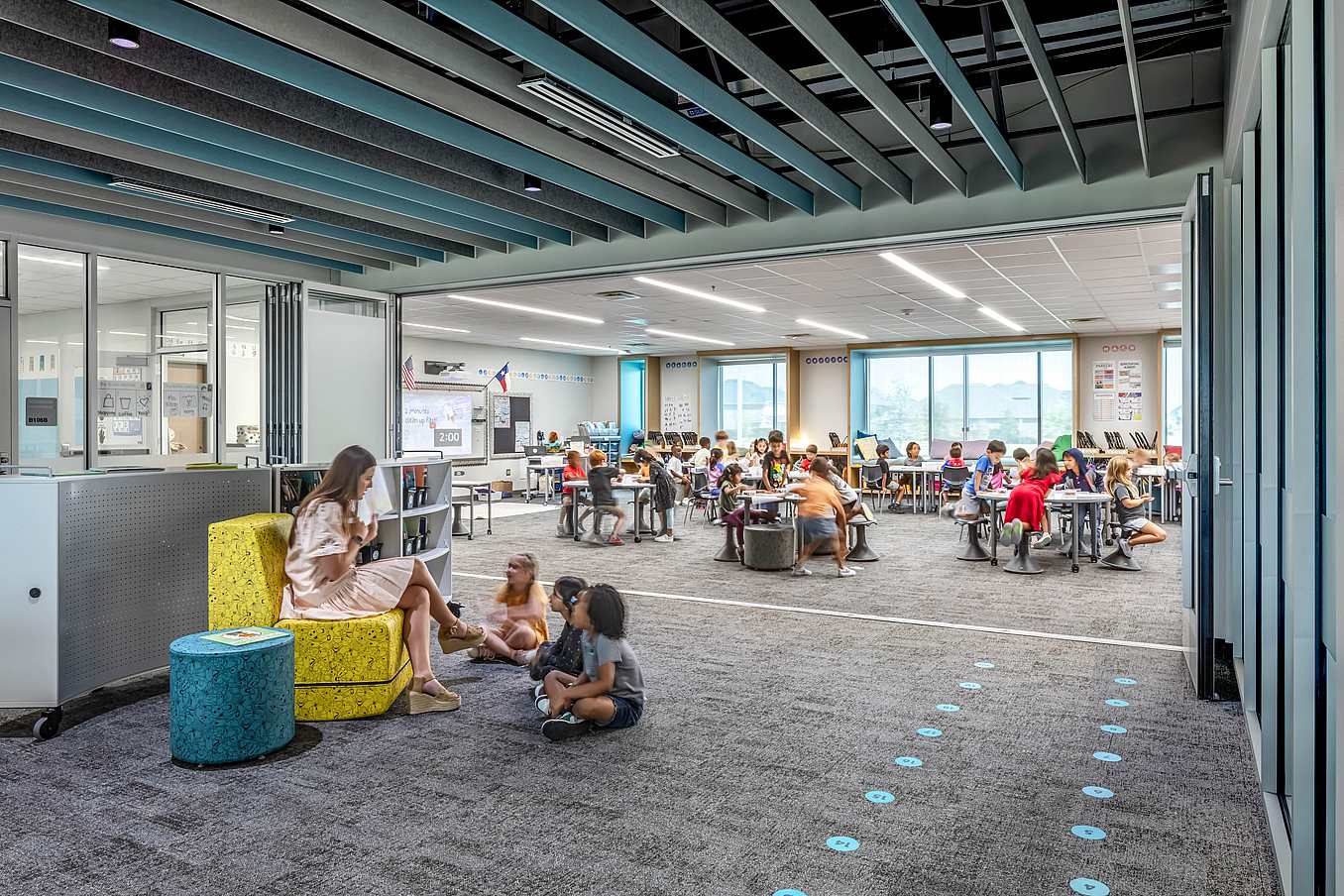 Modern classroom with acoustical commercial folding glass doors and bright lighting, creating an ideal education environment.