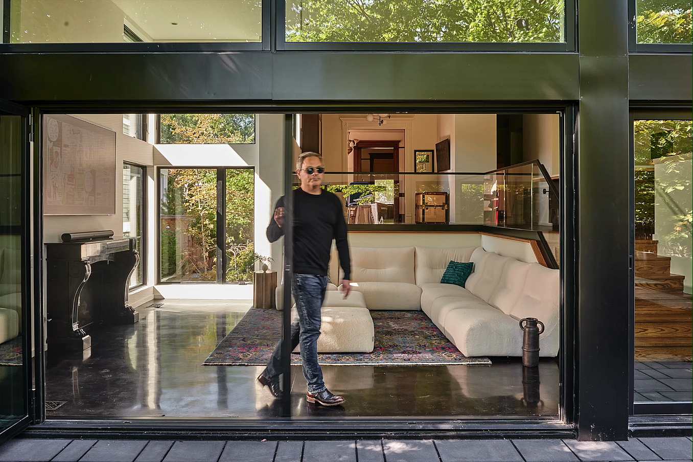 NanaWall third-party retractable screen shown in use with an open glass wall, maintaining airflow while reducing insects and glare