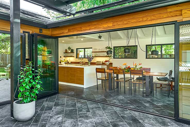 Modern home in Campbell CA using NanaWall SL60 folding glass doors opening dining area to patio