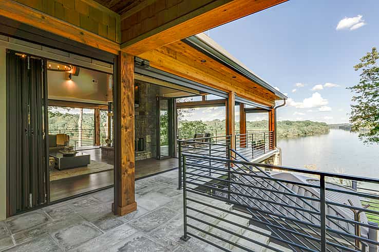 Rustic Lodge in Lebanon TN featuring NanaWall NW Aluminum 840 ultra-slim floor-supported folding glass wall opening to riverside deck