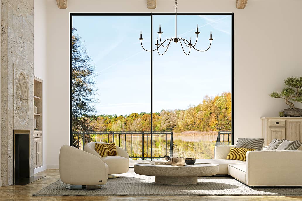 Large panel sliding glass walls offer an uninterrupted view of coastal mountains, lush greenery, and the ocean.