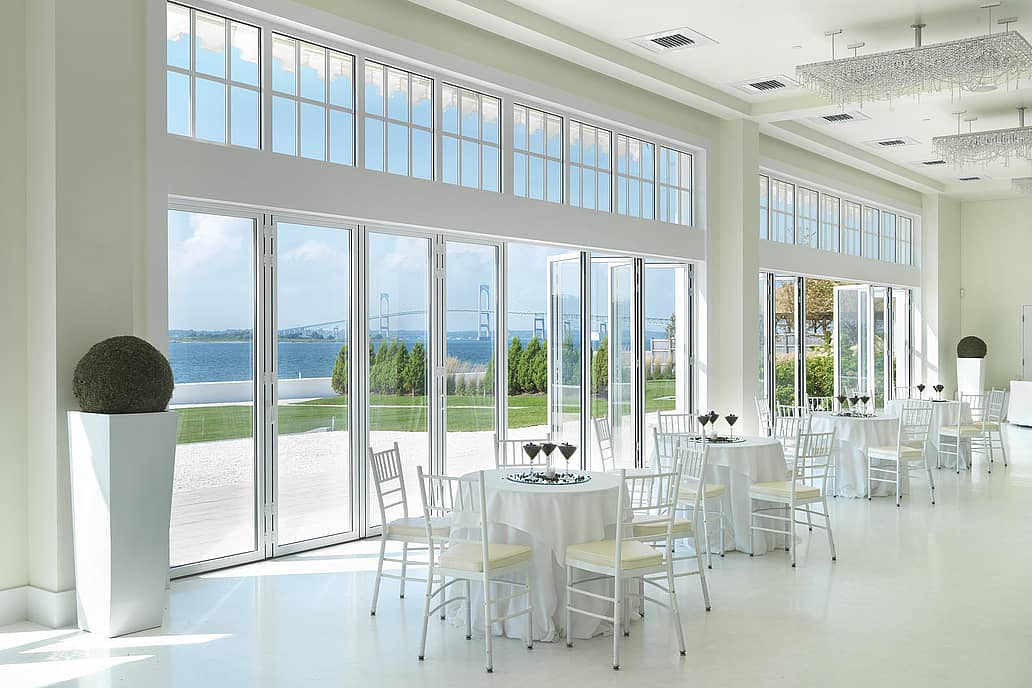 NanaWall folding glass wall system installed at a coastal commercial venue in Newport, Rhode Island, demonstrating large-scale opening capability and performance in demanding environments
