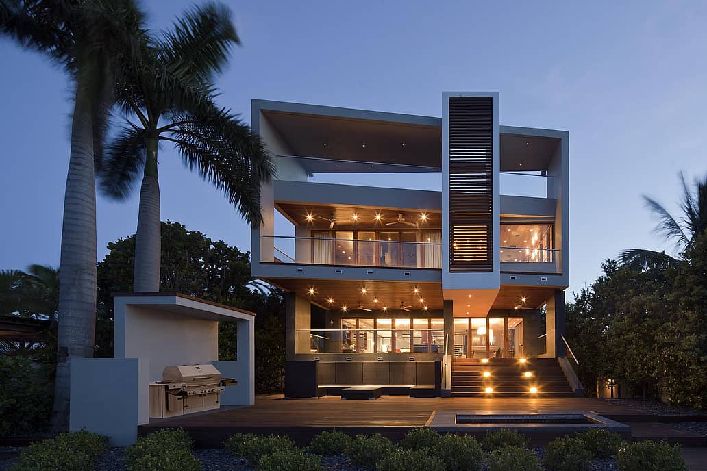 NanaWall SL73 impact-rated folding glass wall system at a Florida coastal residence, combining large openings with hurricane-tested performance