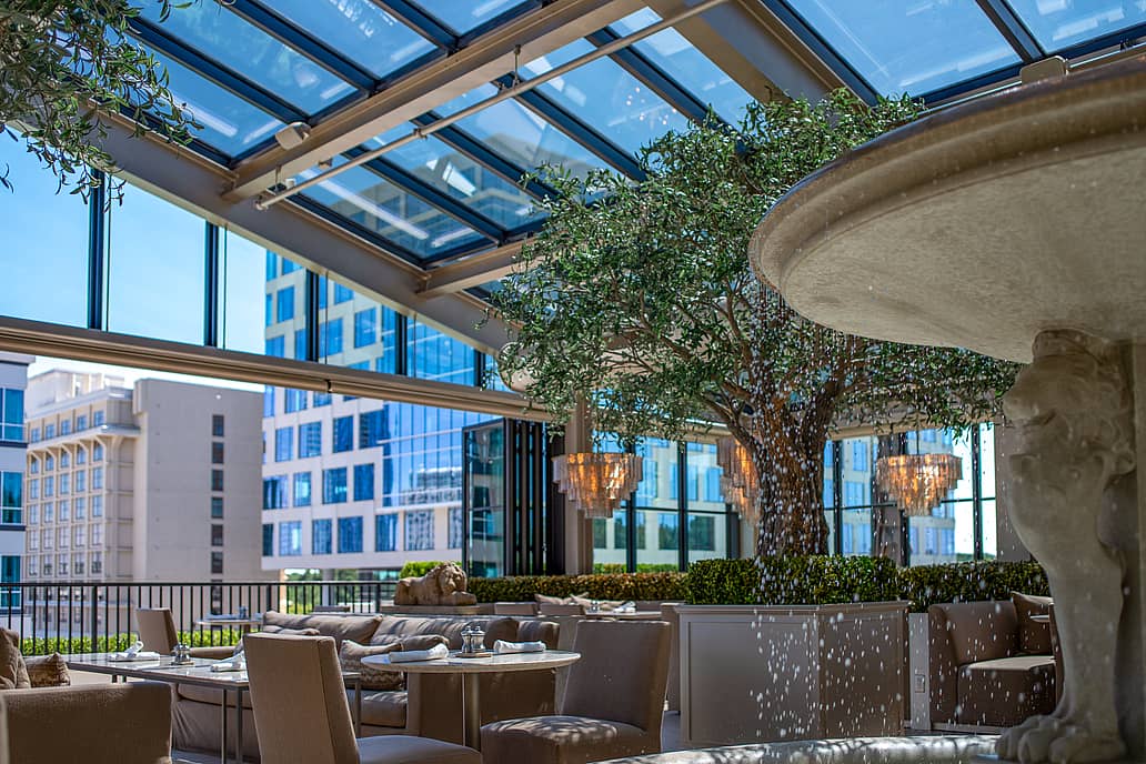 Restoration Hardware rooftop restaurant in Raleigh NC highlighting NanaWall SL70 bifold glass doors as the main feature connecting elegant indoor dining with open-air terrace surrounded by modern décor and city views