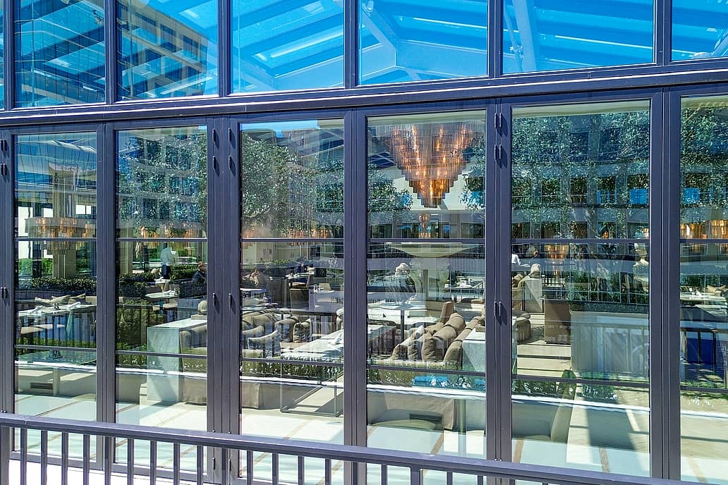 Restoration Hardware rooftop restaurant in Raleigh NC showcasing NanaWall SL70 folding glass doors closed, enclosing elegant dining space with panoramic views