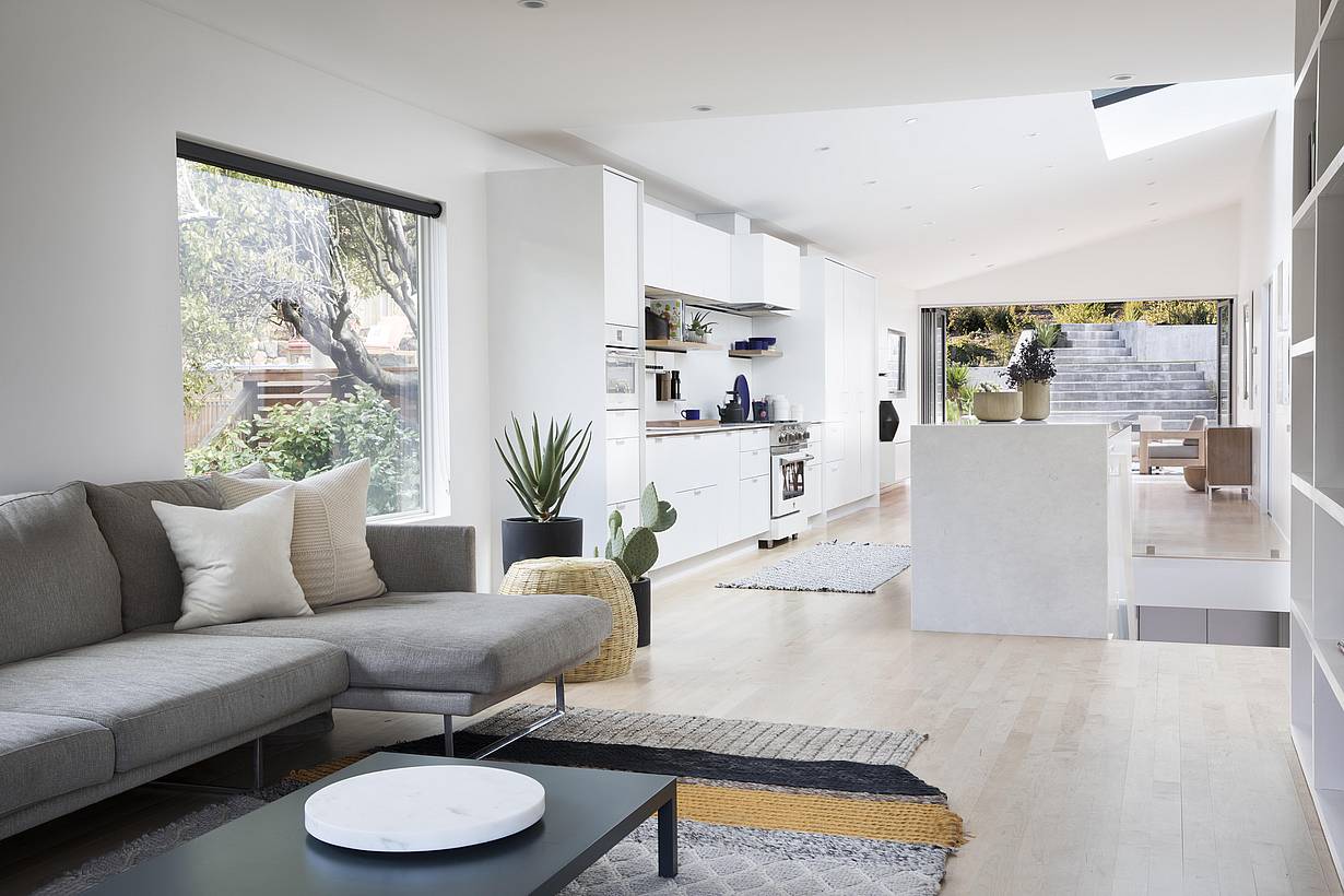 remodeled home with open concept living and opening glass wall