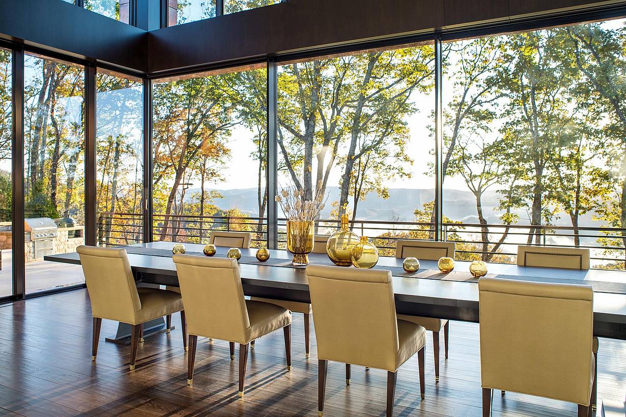 beautiful tree lined view in dining room through cero minimal sliding glass wall