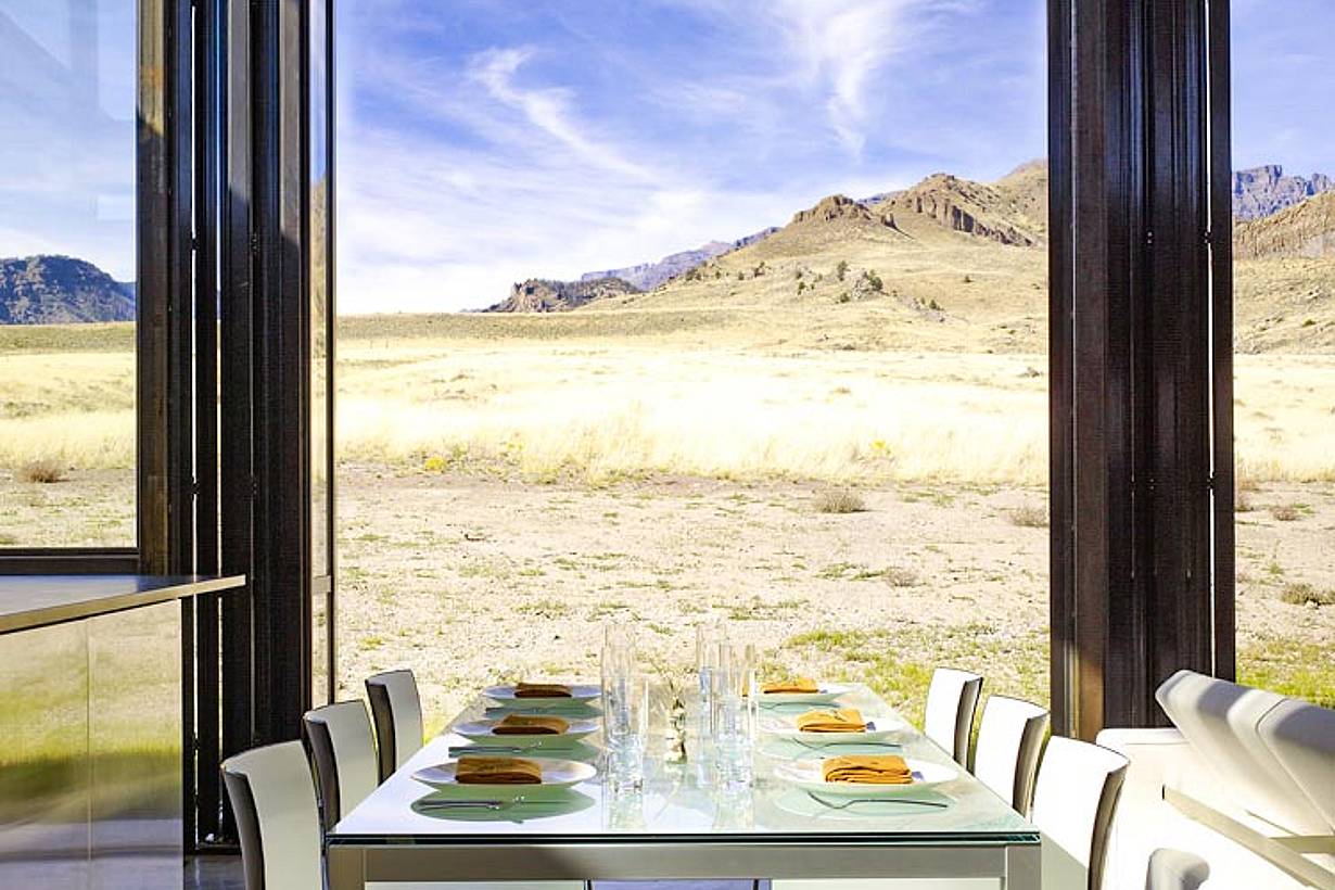 open view of nature out of folding glass wall in dining room