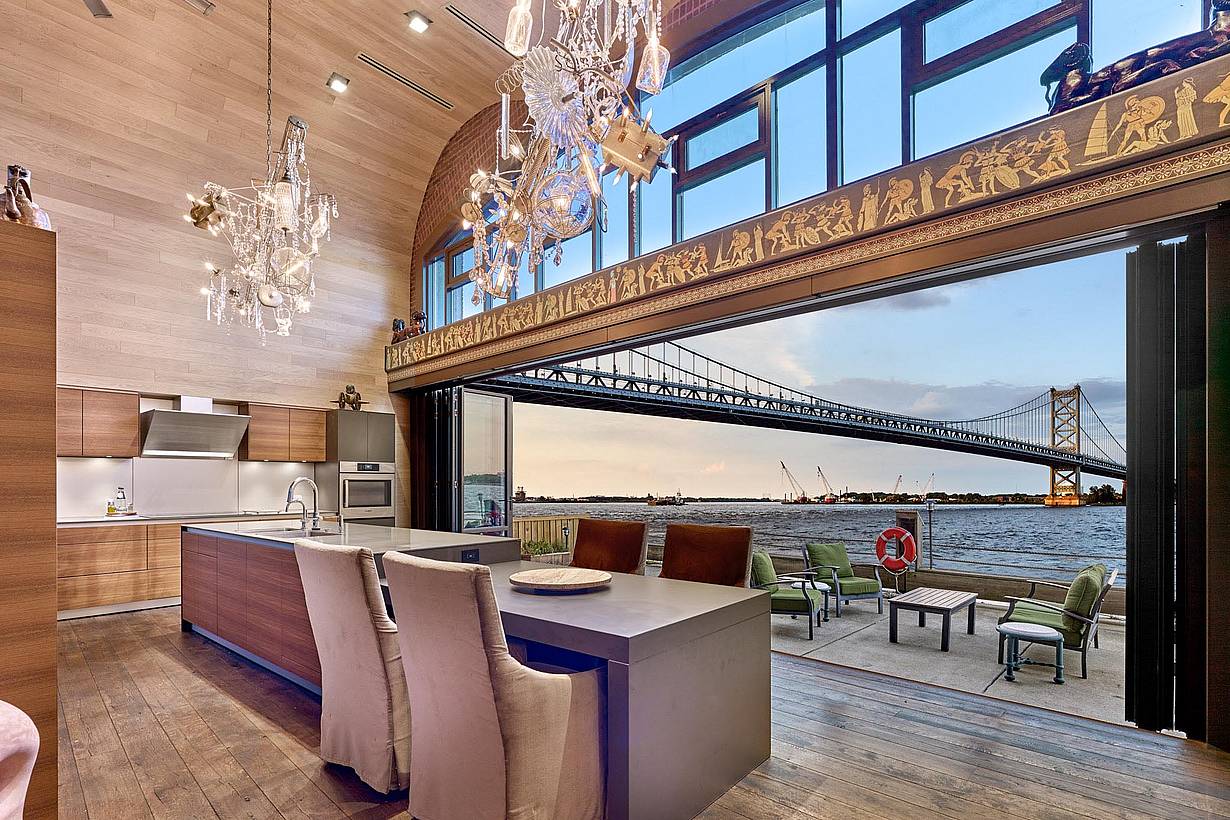 grand philadelphia kitchen with bridge view through opening glass wall