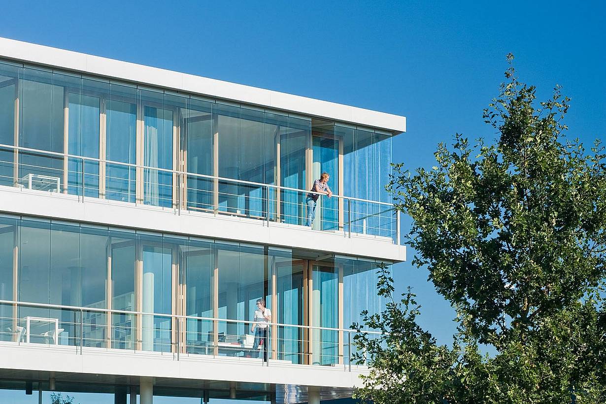 emploees enjoy the benefits of opening glass walls in breathable building in an office
