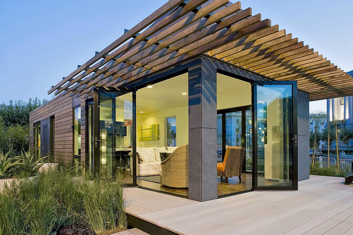 modern tiny living home with two folding glass walls opening to the outdoors