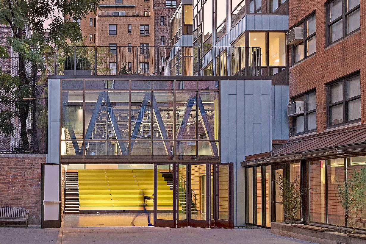 teacher opening folding glass wall in 21st century school design
