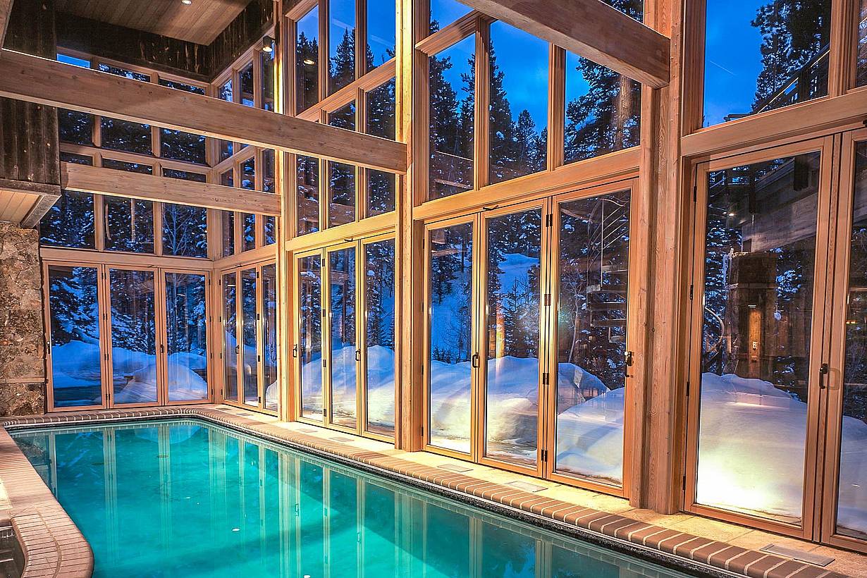 breathtaking winter getaway pool house with operable glass walls