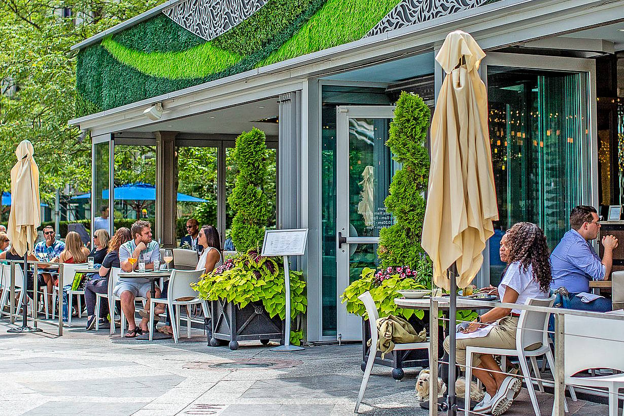 indoor outdoor restaurant with exterior stacking glass doors attracts customers
