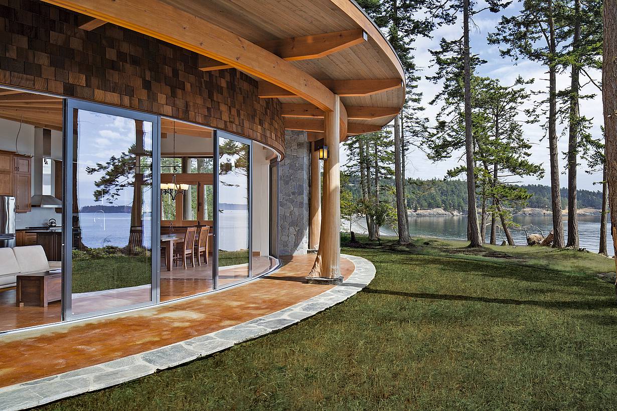 curved sliding glass door system in a waterfront home