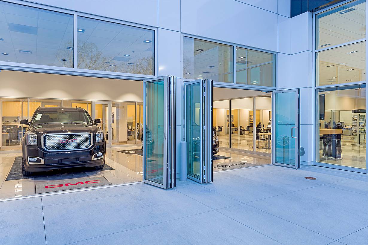 folding glass door systems in auto dealership design