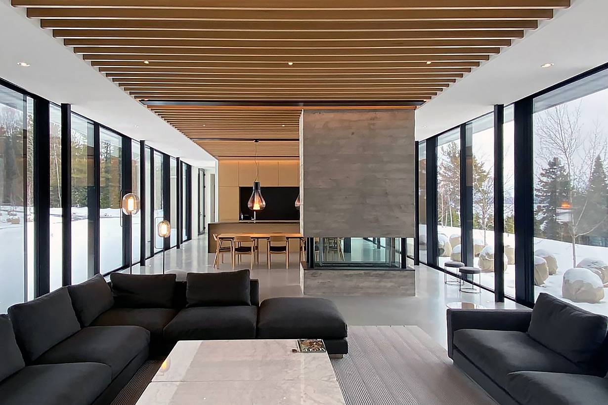 A living room with full floor to ceiling sliding glass panels